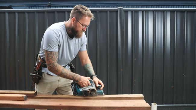 Barefoot Building FNQ owner Marcus Wilson at work planning timber in Hollowys Beach. Picture: Brendan Radke