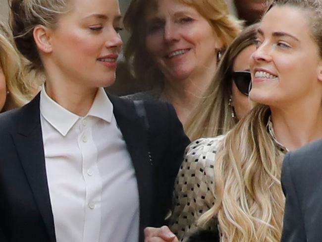 US actress Amber Heard (left) leaves hand-in-hand with her sister Whitney Henriquez. Picture: AFP