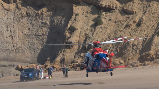 Man rescued after hitting head on reef at Bird Rock, Jan Juc. Locals and paramedics worked together to treat and move the man, using a resident's ute. Pictures: Shaun Viljoen