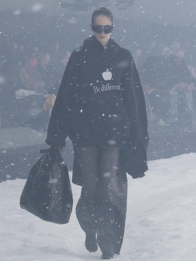 Models trudged through a glassed-in snow globe of a set with paper snow blowing in their faces.