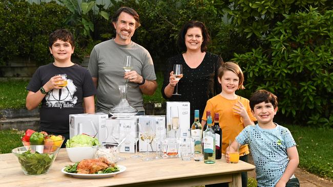 Darian Clark with wife Renee and their children Terran, Elliot and Raphael with the Coles glassware range. Picture: Nathan Hopkins