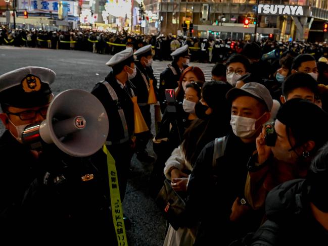 Police direct people as they try to cross the street ahead of midnight to celebrate the start of the New Year at Shibuya Crossing. Picture: AFP