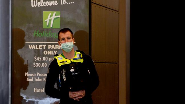 A police officer outside the Holiday Inn on Flinders Lane on Tuesday morning: Picture: NCA NewsWire / Andrew Henshaw