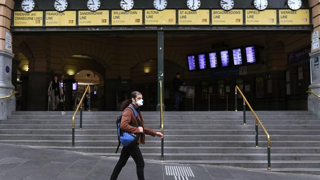 A man walks past the near-deserted Flinders Street Station. Picture: AFP