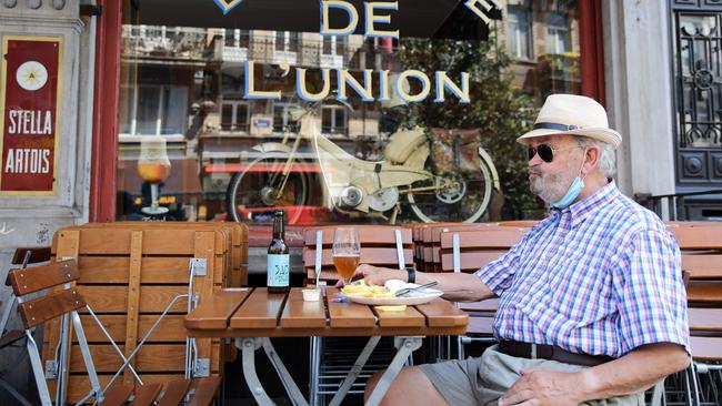 A man eats at a terrace at the Parvis de Saint-Gilles in Brussels last week. Picture: AFP