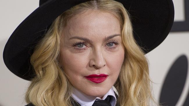 (FILES) In this January 16, 2014 file photo, singer Madonna arrives on the red carpet for the 56th Grammy Awards at the Staples Center in Los Angeles. Madonna on March 2, 2015 announced concerts across North America and Europe to support her new album, her first extensive shows since a high-grossing and controversy-filled global tour in 2012. The pop superstar will start a 35-date tour to accompany her "Rebel Heart" album on August 29 in Miami, with concerts across North America as well as a show in Puerto Rico before she heads to Europe in November. Madonna's last scheduled concert is on December 20 in Glasgow, but a statement from concert promoters said that she would soon announce additional dates in Asia and Australia. AFP PHOTO/ROBYN BECK / FILES