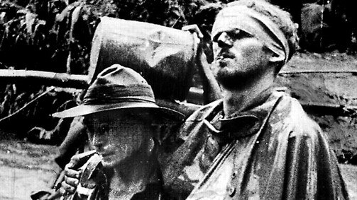 Millennium collection - 1000 years of war - Wounded Aust soldier William 'Wally' Johnson (r) being lead by medic G R C Ayer (l) on the Kokoda Trail, Papua New Guinea during World War II. two historical /World/War/1939/45