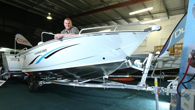 Shaun Hose from Nitro Marine with a boat and trailer in his showroom. Picture Glenn Hampson