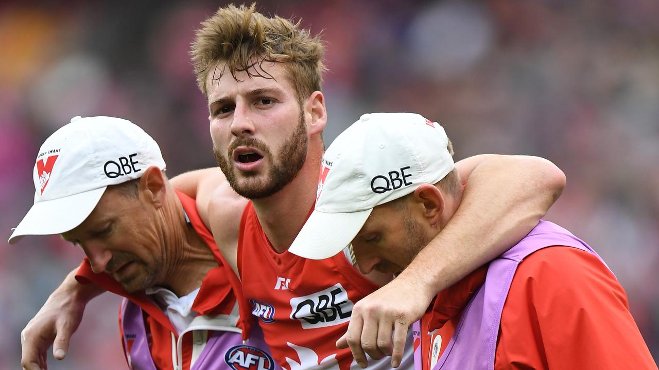 Alex Johnson is helped off the MCG after rupturing his ACL in Round 21.