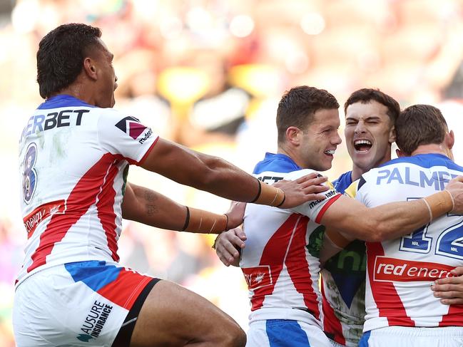 BRISBANE, AUSTRALIA - MAY 18: David Armstrong of the Knights celebrates with his team mates after scoring a try during the round 11 NRL match between Gold Coast Titans and Newcastle Knights at Suncorp Stadium, on May 18, 2024, in Brisbane, Australia. (Photo by Hannah Peters/Getty Images)