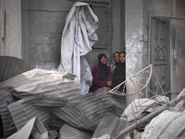 Palestinian women watch as residents search the rubble of a house targeted by an Israeli army strike that killed killing at least five members of the Abu Sahloul family in Khan Yunis. Picture: AP