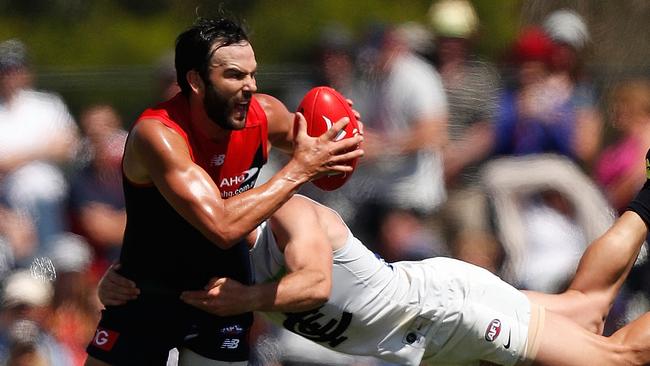 Jordan Lewis prepares to dish off a handball despite a flying tackle from Carlton’s Sam Docherty at Casey Fields. Picture: Getty Images