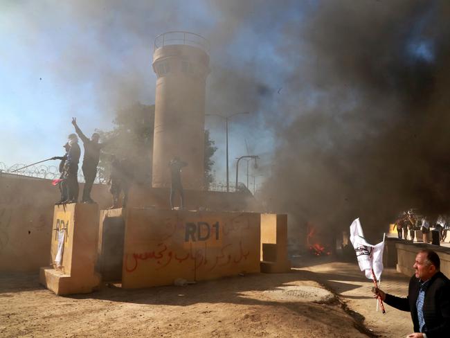 Protesters burn property in front of the US embassy compound, in Baghdad, Iraq. Picture: AP