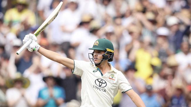 Konstas raises his bat after passing 50. Picture: AFP