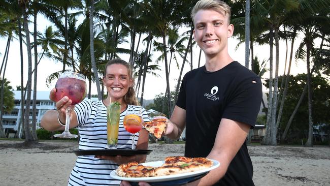 Portofino hostess Elyssa Cawood and Chill Cafe waiter Scott Barry are ready to serve tourists at Palm Cove beach, Cairns. Picture: Brendan Radke