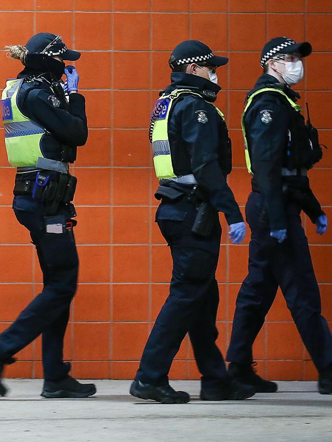 Police enter one of the buildings. Picture: Ian Currie