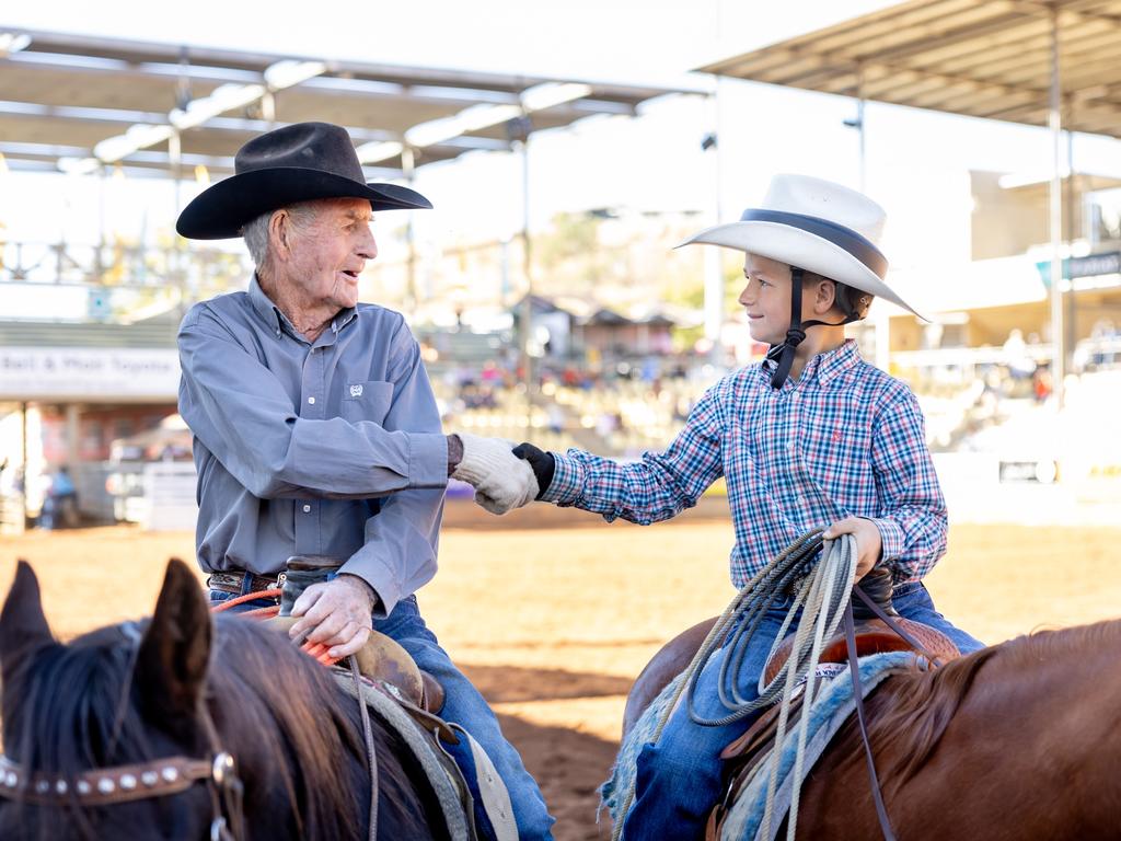 Bob Holder, 93, and Tate Smith, 9, competed in the team roping at the Mount Isa Mines Rodeo. Picture: Luke Marsden.