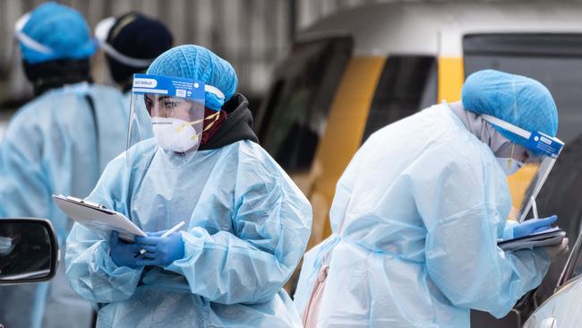 Workers at a Covid-19 drive through test centre. Picture: NCA NewsWire