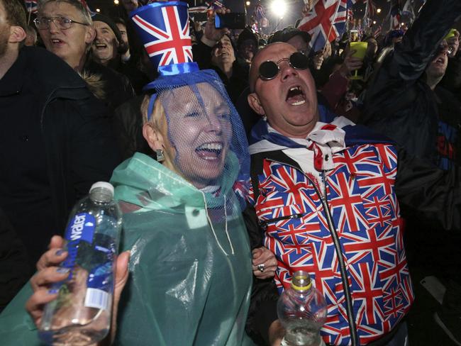 Brexit supporters celebrate during a rally in parliament square in London, England. Picture: AP