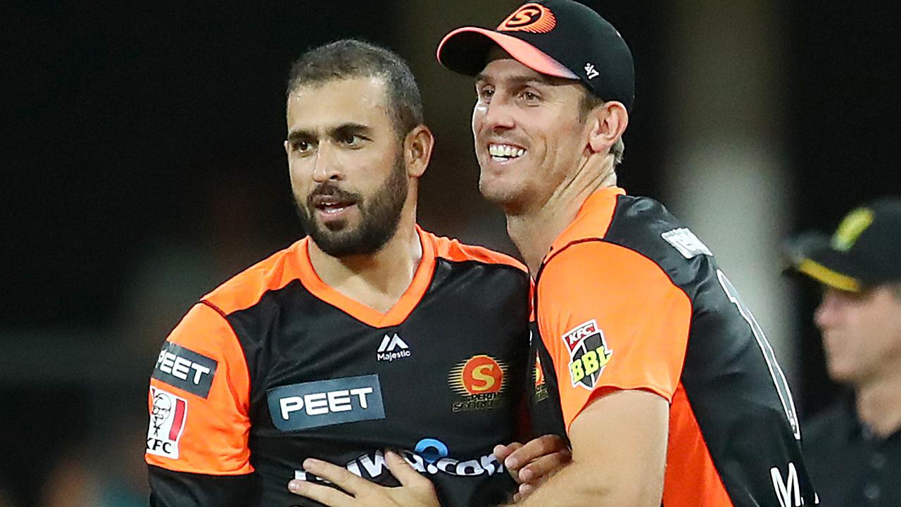 Fawad Ahmed (left) and Mitchell Marsh celebrate a wicket against Brisbane Heat. Picture: Jono Searle/Getty Images.