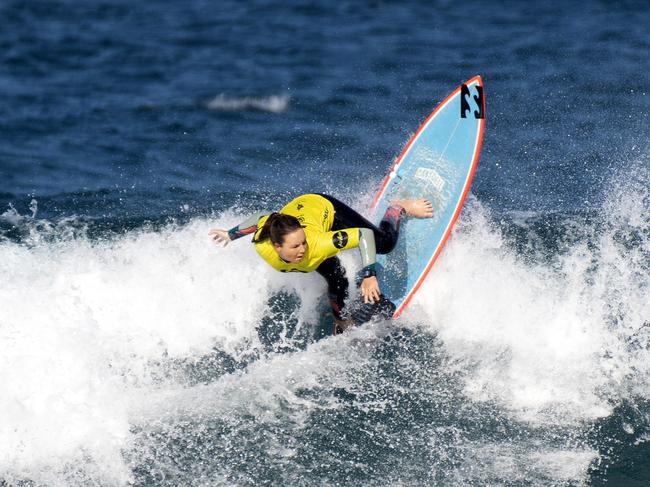 CARVING IT UP: Wooli surfer Carly Shanahan in the quarter finals of the Woolworths NSW Junior Surfing Titles in Coffs Harbour on Sunday.