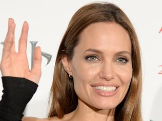 US actress Angelina Jolie waves as she poses during a photo session before a press conference to promote her latest film "Maleficent" in Tokyo on June 24, 2014. The film, which opened in the US in late May, will hit cinemas across Japan on July 5. AFP PHOTO / Toru YAMANAKA