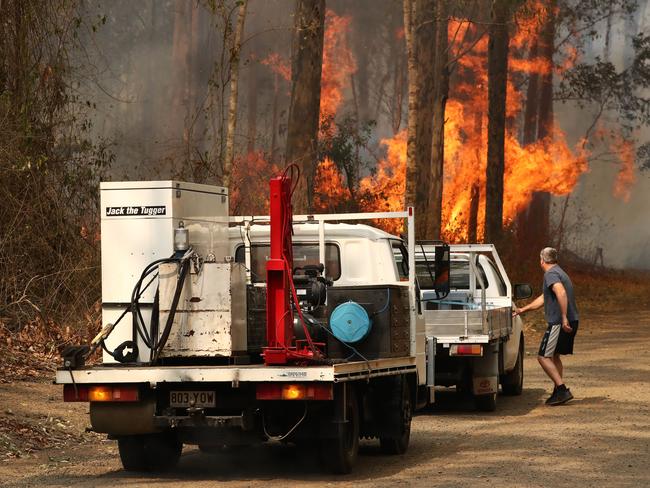 Firefighters battle bushfires in Busbys Flat, northern NSW, Wednesday, October 9, 2019. (AAP Image/Jason O'Brien)