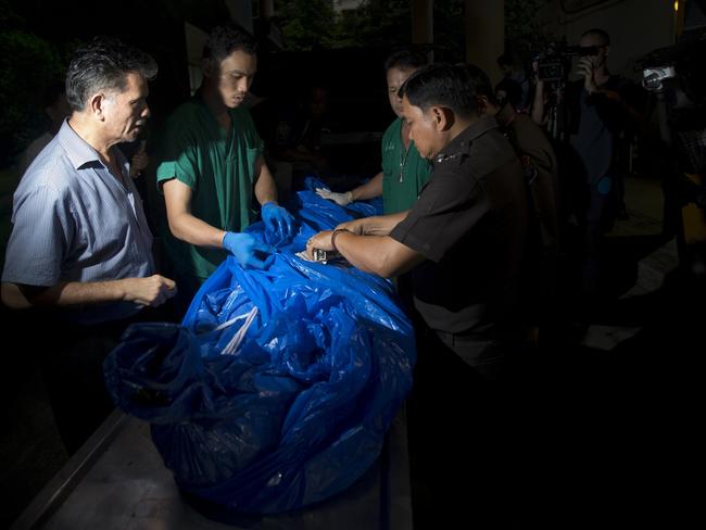 The body of one of the slain British tourists, Hannah Witheridge, wrapped in plastic sheet, is carried at a forensic police facility in Bangkok, Thailand. Picture: Sakchai Lalit