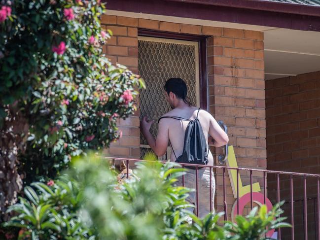 A shirtless man waits for his order last month. Picture: Jason Edwards