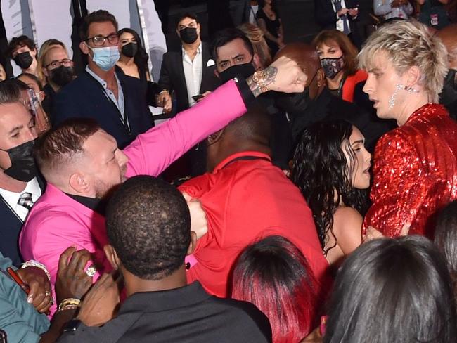 Mandatory Credit: Photo by Stephen Lovekin/Shutterstock (12439060df) Conor McGregor throws a punch at Machine Gun Kelly MTV Video Music Awards, Arrivals, New York, USA - 12 Sep 2021