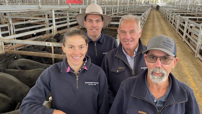 Annabel, Sam and father Malcolm Davies with employee Darryl Thompson (right). The Davies family sold a huge line of 570 Angus steers. Picture: Petra Oates