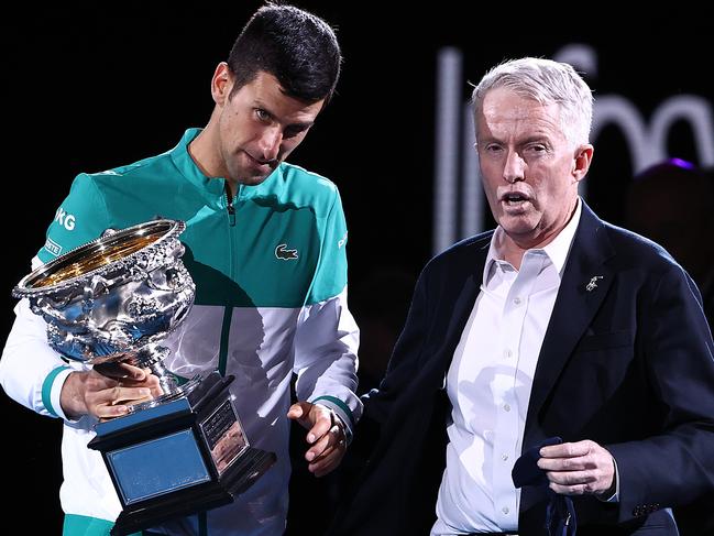 MELBOURNE, AUSTRALIA - FEBRUARY 21: Novak Djokovic of Serbia speaks with CEO of Tennis Australia Craig Tiley as he holds the Norman Brookes Challenge Cup following victory in his MenÃ¢â¬â¢s Singles Final match against Daniil Medvedev of Russia  during day 14 of the 2021 Australian Open at Melbourne Park on February 21, 2021 in Melbourne, Australia. (Photo by Cameron Spencer/Getty Images)