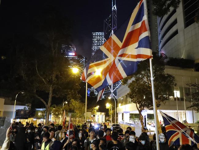 Protesters wave a British flag as they gather for a rally outside of the British Consulate in Hong Kong. Picture: AP