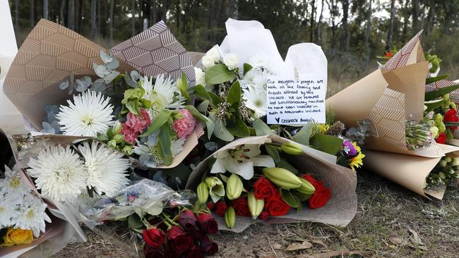 Floral tributes left near the scene of the horrific bus crash, which killed 10 people and injured 25 others at Greta in the Hunter wine country. Picture: Jonathan Ng