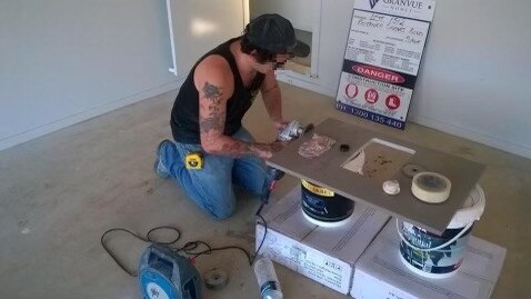 Mr Donnelly's colleague sanding engineered stone, unmasked. Picture: Supplied.