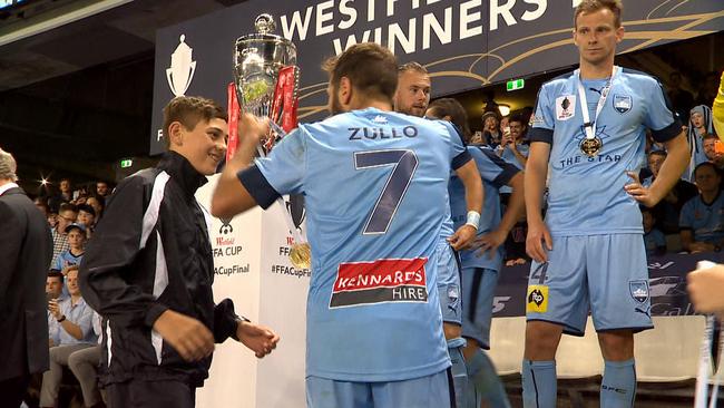 Michael Zullo gives his medal to a ball boy.