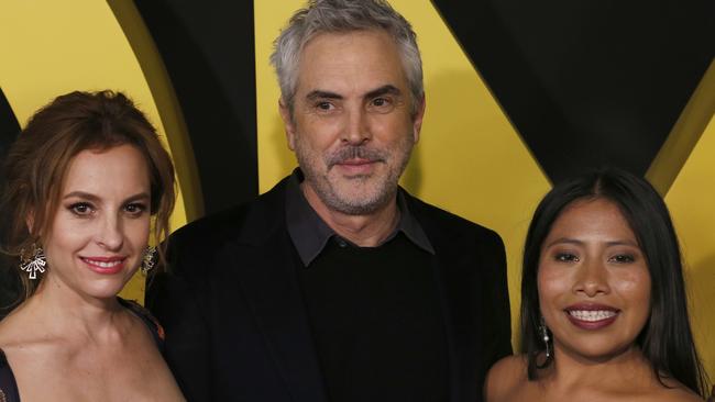 Mexican film director Alfonso Cuaron with actresses Mariana de Tavira, left, and Yalitza Aparicio on the red carpet for their film Roma in Mexico City. Picture: AP