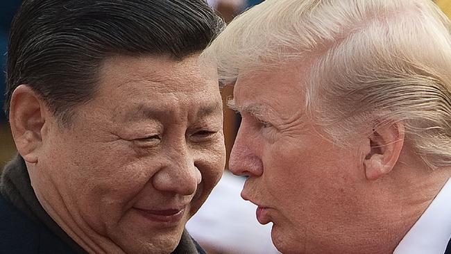 China's President Xi Jinping (L) and US President Donald Trump attend a welcome ceremony at the Great Hall of the People in Beijing earlier today. (Image: AFP/ Nicolas Asfouri)