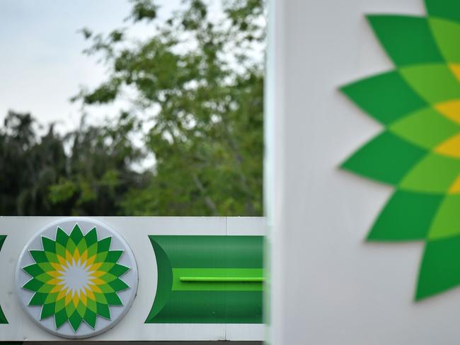 BP logos are seen at a BP petrol and diesel filling station in Hildenborough, southeast of London on June 15, 2020, following the announcement that the oil giant will take a hit of up to $17.5 billion (11.4 billion euros and 15.3 billion euros), due to the ongoing COVID-19 global pandemic. - British energy giant BP said Monday that it will take a hit of up to $17.5 billion in the second quarter as "sustained" coronavirus fallout ravages global oil demand. The company, fresh from outlining plans to axe almost 10,000 jobs on COVID-19 fallout, said in a statement that it will suffer a negative impact of between $13 billion and $17.5 billion (11.4 billion euros and 15.3 billion euros) in non-cash impairments and write-offs. (Photo by Ben STANSALL / AFP)