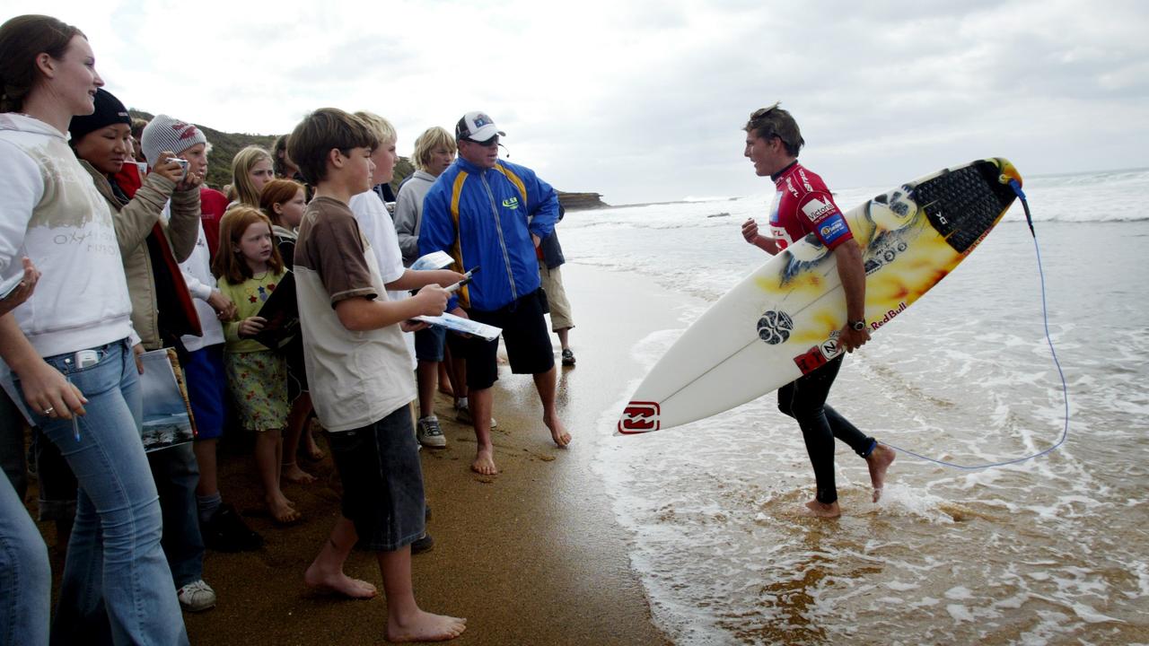 Andy deals irons surfboard