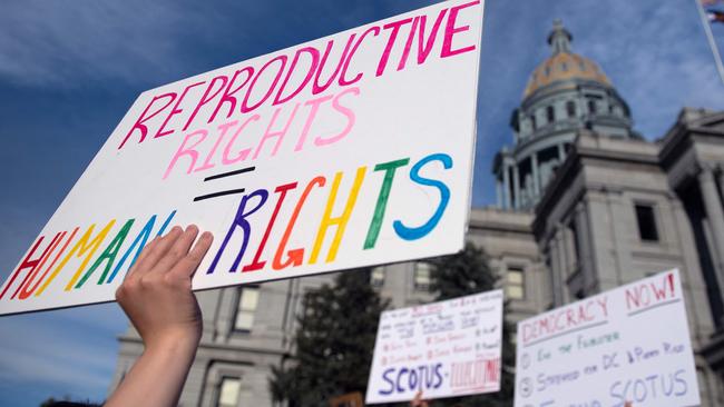 (FILES) In this file photo taken on June 27, 2022, abortion rights activists protest in front of the Colorado State Capitol in Denver, Colorado. - Trigger laws outlawing abortion took effect in a trio of US states on August 25, 2022, further restricting access to elective terminations for millions of women despite some signs of popular and judicial pushback. Two months after the Supreme Court struck down the constitutional right to abortion, nearly 21 million women have already lost access to the procedure in their home states, according to an analysis by The Washington Post. And with Idaho, Tennessee and Texas joining 10 other Republican-ruled states on Thursday in implementing near-total bans on abortion that number is set to rise. Another dozen states are expected to follow suit with their own restrictions. (Photo by Jason Connolly / AFP)