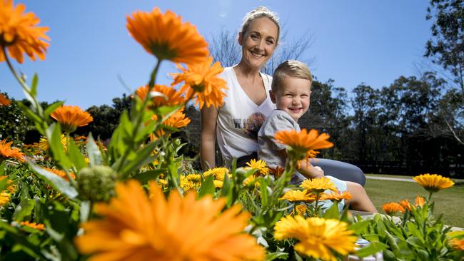 Bianca Stenton with her son Nate, 3, checking out the flowers on the last day of winter at the Gold Coast Regional Botanic Gardens. Picture: Jerad Williams.