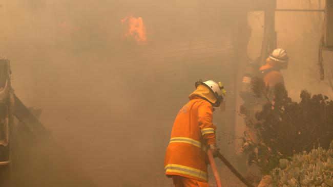 CFS firefighters put out fires on Jacaranda Drive at Woodside in the Adelaide Hills in Adelaide, Friday, December 20, 2019. Photo: Kelly Barnes / AAP.