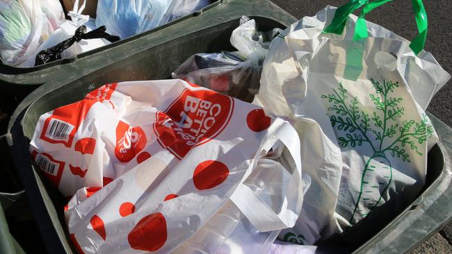 ‘Reusable’ Woolies and Coles bags on their way into landfill. Picture: John Grainger