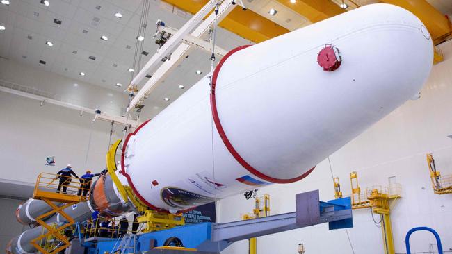 Russian technicians at the Vostochny cosmodrome assemble a Soyuz 2.1b rocket carrying the Luna-25 lander. Picture: AFP