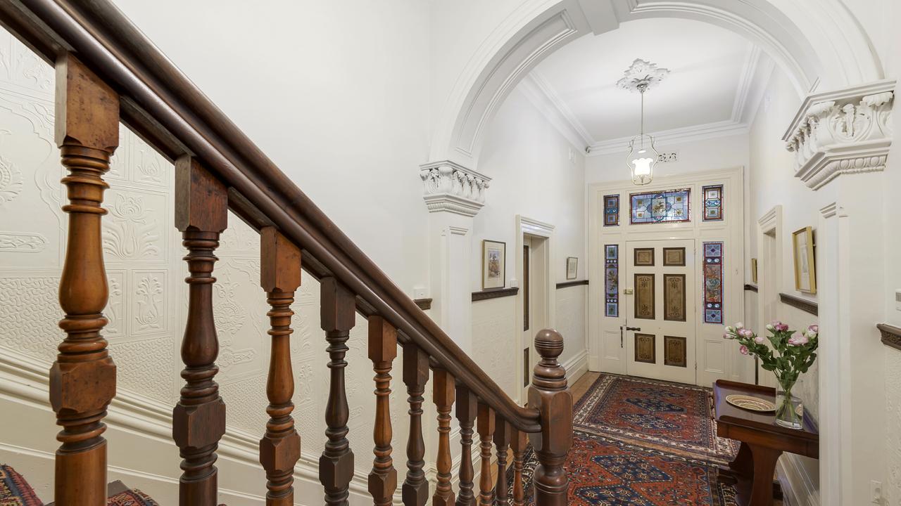 Decorative arches, leadlights and a polished timber staircase all greet you upon entry.