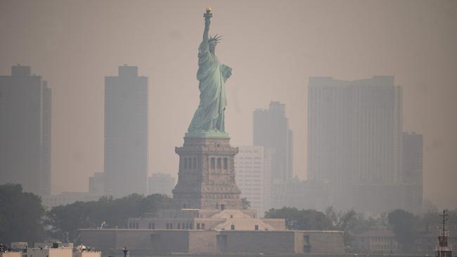 The Statue of Liberty from the Staten Island Ferry during heavy smog in New York on June 6. (Photo by Ed JONES / AFP)