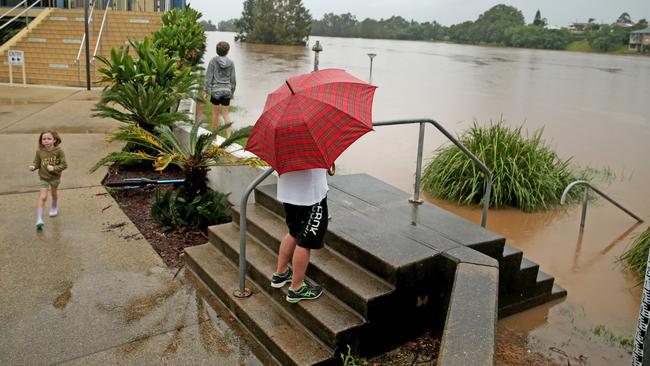 Heavy rain continues to batter the NSW mid north coast causing major flooding. Kempsey residents check the water levels at the towns levy wall. Picture: Nathan Edwards