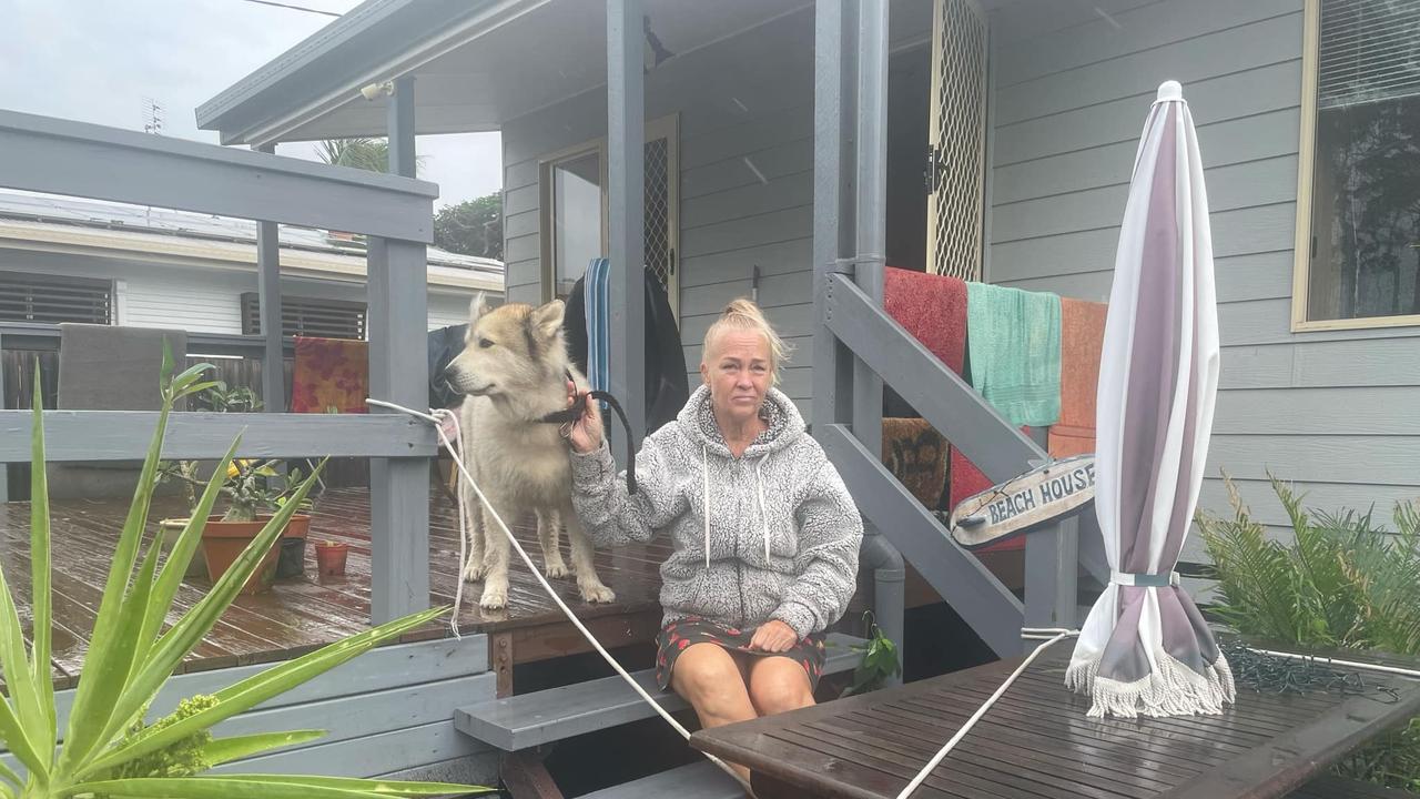 Yola Ashfield and her dog, Ruski, have been trapped in their home after water rushed into their yard. Picture: Phillip Fynes-Clinton