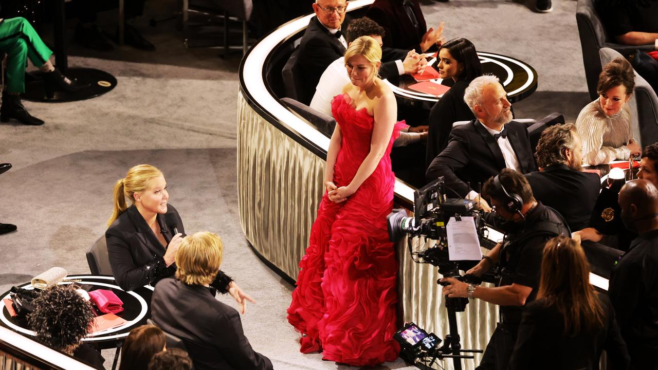 Kirsten Dunst stands aside as Amy Schumer chats with her husband Jesse Plemons. (Photo by Neilson Barnard/Getty Images)